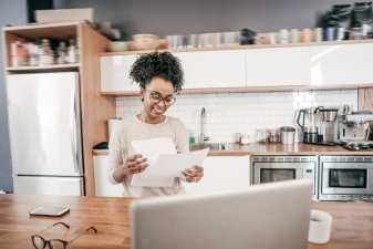 Business owner looks at payroll check